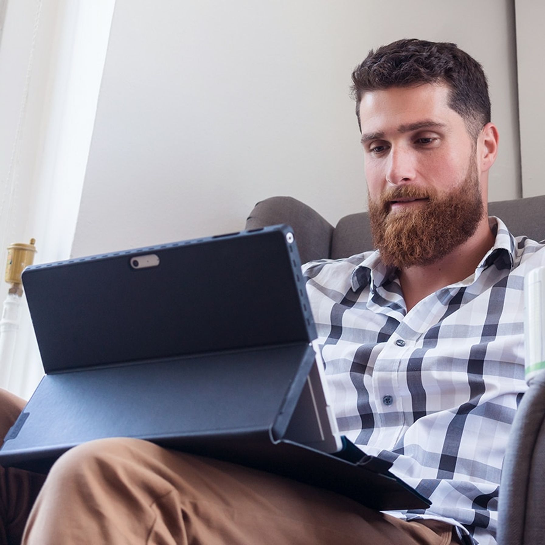 Man in a chair looking at Ipad