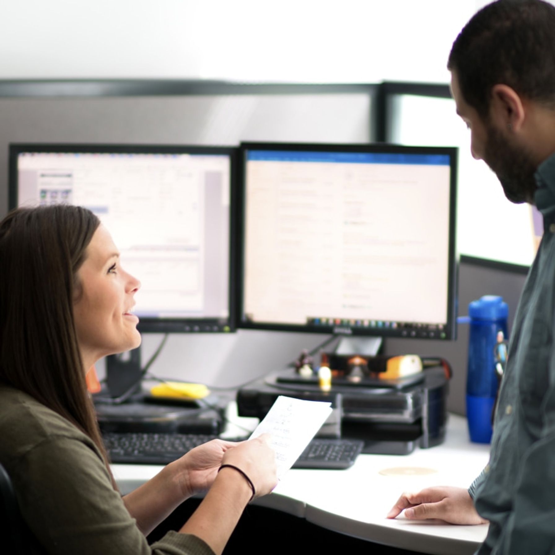 A man helping women at her work desk