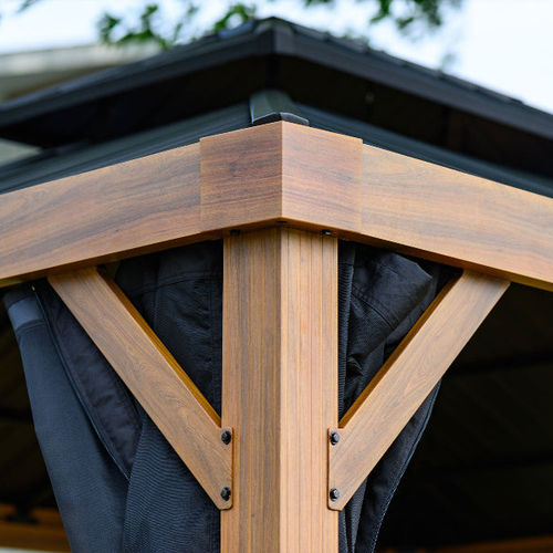 Stylish wooden gazebo corner showcasing sturdy construction and black drapes