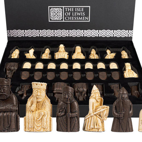 Isle of Lewis chess set featuring intricately carved ivory and dark pieces in display box