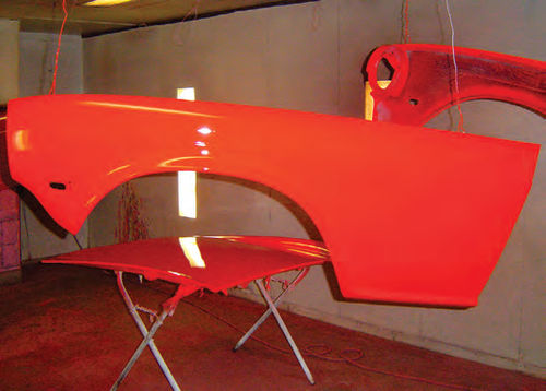 Photo 19. Body panels receive their Viper red coats in the paint booth.