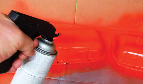 Photo 5. Applying a light coat with an aerosol can equipped with a trigger grip.