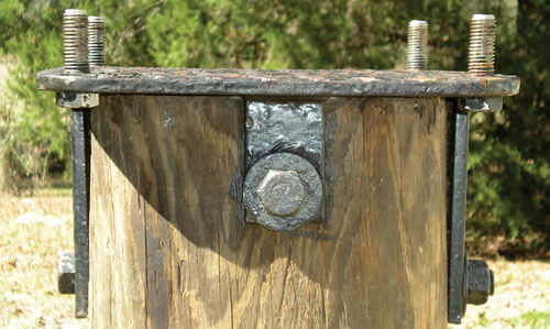 Photo 5. A close-up of the fixture plate with its welded-on attachment straps.