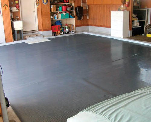 Any minor problems with your garage floor will be “swept under” this new polyvinyl covering.