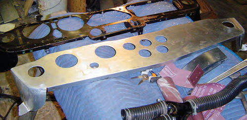 Photo 22. With the revisions made regarding the instruments, the old dash backing plate at the top of the photo was out and a new aluminum replacement was fabricated.