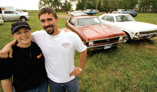 Joanie and Mike—and their cars—get together for a break between runs on the track.