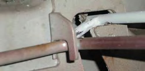 Photo 6. Once in the pivot hole, the rod is lifted and inserted into the notch where it rests.