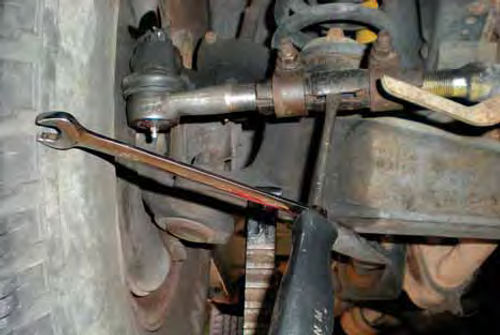 Photo 10. If a sleeve still has a tight grip on the tie rod end(s), try this with a screwdriver and wrench.