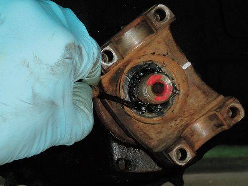 Photo 14. A non-hardening sealer is used to fill the gap from the flange to the pinion to avoid grease leakage.