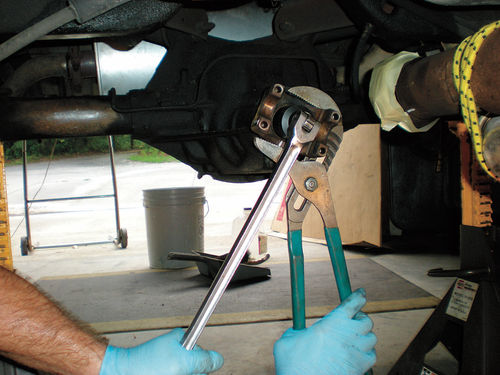 Photo 8. Slip joint pliers will hold the flange while a breaker bar with a 11 ⁄2” socket loosens the nut.