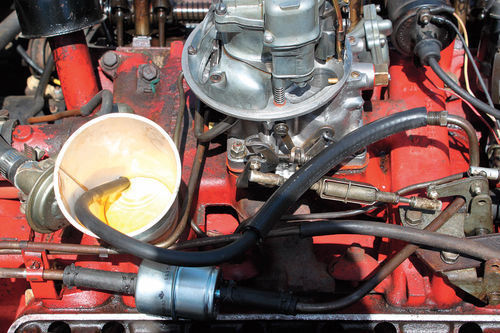 Photo 15B. Fuel Flow: Is there clean fuel? Install fuel line at carb inlet fitting and flow gas into a plastic cup during a five-second crank. Look for strong pump squirts and check for small particles (rust).