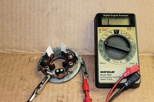 Photo 10. Plate Insulation Test: When cleaning a plate or installing new points, measure the resistance with both points open with paper strips.