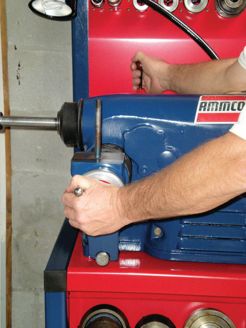 Photo 2. With a newer #4000 machine, holding the feed lever engaged while turning the hand wheel will free the cross feed, allowing removal.