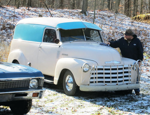 In a photo taken a few months ago, Dennis clears snow from one of his drivers, a 1949 Chevy panel truck. That’s his 1970 Nova parked to the left.