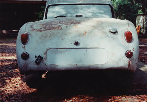 Photo 1. The lumpy appearance at the bottom of the rear panel (up arrow) is a clear indicator that a problem exists where the trunk floor meets the rear sheet metal.