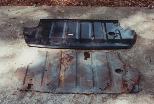 Photo 2. With a replacement panel in hand for reference, the rusty trunk floor has been cut out.