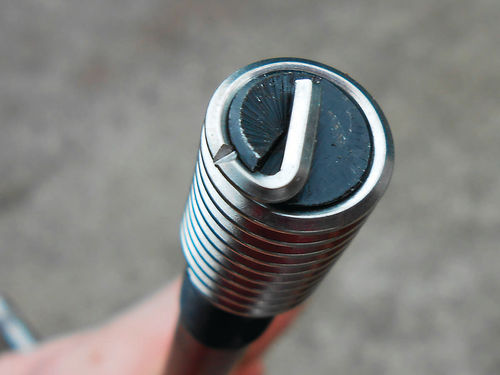 Photo 6. The insert threads onto the installation tool like a nut onto a bolt. The notch is where the tang will be broken.