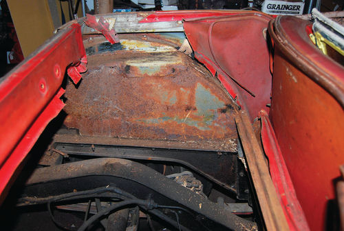 The floor of the MG TF side curtain bin that lies between the wheel wells has been removed.