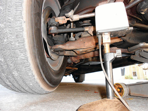 Photo 15. For checking dynamic balance, the pick-up is positioned against the steering knuckle extension as seen here, or the brake backing plate.