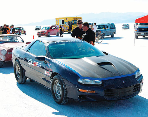 Taped up for improved aerodynamics, the Camaro sits in line waiting its turn for another run on the Bonneville Salt Flats.