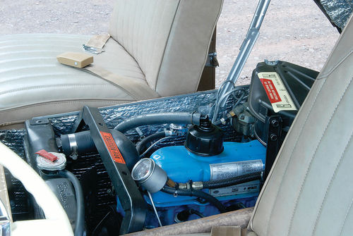 The 240-cubic-inch six is accessible for routine maintenance by opening the cover between the front seats.