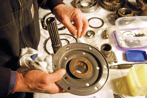 11. Here Vince is holding and inspecting the reverse drive gear flange after removal of the snap rings and the reverse center gear.