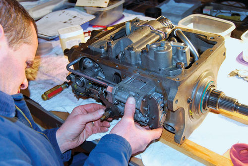 12. Vince Sauberlich bolts the control valve assembly to the transmission.