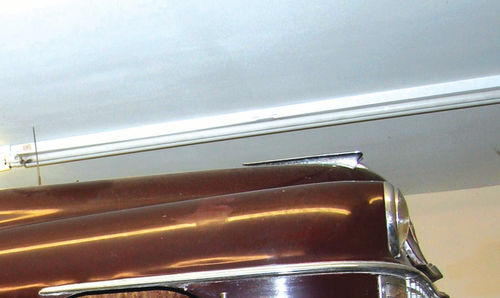This close-up shows a side view of the headlight “door” at the front of the fender.