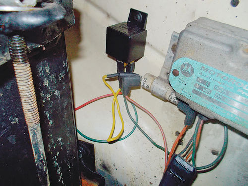 The electrical relay for the pump is located to the left of the voltage regulator and a resistor.