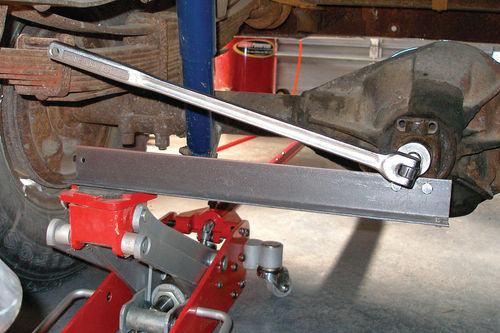 Photo 57. I bolted one end of a piece of angle iron to the U-joint yoke and supported its free end with my floor jack.