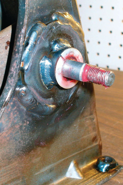 Photo 62. By welding a heavy washer and chunk of old wrist pin to both ends of a worn mounting bracket, I got the clutch and brake pedals working smoothly again.