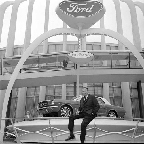 Henry Ford II poses with the new pony in New York and (below) Ford Division Vice President Lee Iacocca presents the Mustang to the media.