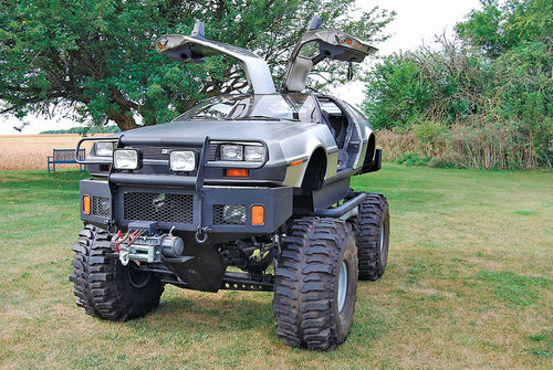 The DeLorean monster truck sits high above the ground.