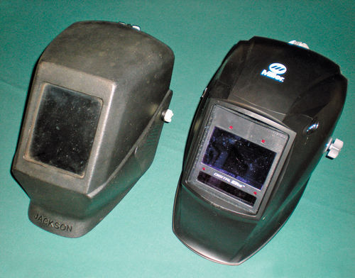 Photo 11. To the left is a typical “passive” welding helmet, and next to it is an auto-darkening version.