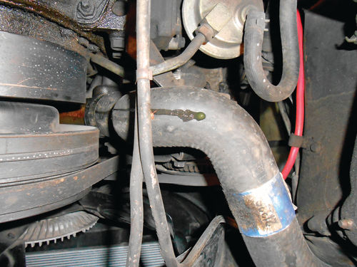 7. Looking up from underneath the vehicle, antifreeze can be seen traveling down the hose from the pump. That’s a certain sign of pump failure.