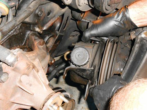 29. The power steering pump is slid off the stud, and allowed to rest between the crank pulley and steering box.