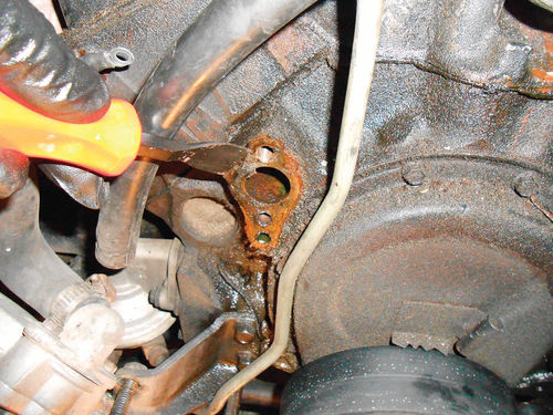 Photo 47. Scrape the old gasket off the mounting ports on the block, and keep fragments from entering the cooling system.