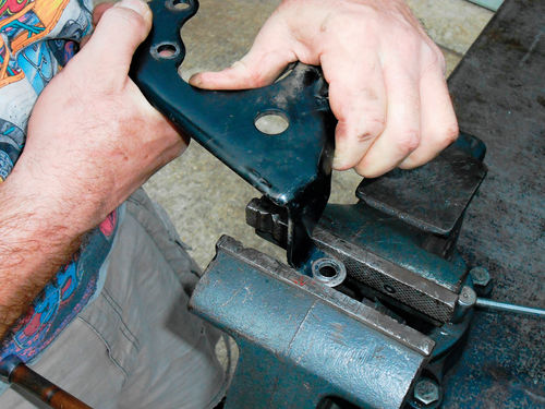 Photo 54. It was surprisingly easy to straighten the bracket arm with the help of a bench vise.