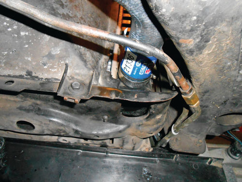 Photo 58. The lower radiator hose clamp is positioned with the screw straight up and on the frame side.