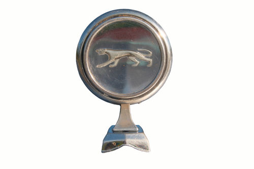 The car’s hood ornament with its stalking cougar on a clear disc was patterned after an antique pocket watch.