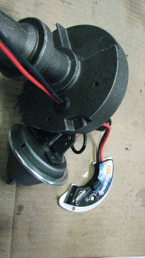 Photo 15. A new grommet is inserted in the bottom of the distributor housing and the wires are routed through the hole in the distributor baseplate.