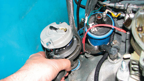 Photo 17. The new distributor is installed back into the motor, carefully aligning the rotor and housing at the same angle as it was when it was removed. Note the new base gasket to prevent oil leaks.