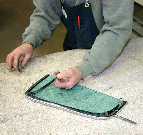 Cut away excess rubber seal using a sharp utility knife, being careful not to scratch the glass.