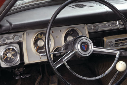 A careful look at the dash area reveals a tach and a four-speed as well as the “Valiant” badge in the center of the horn ring.