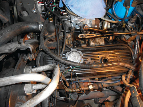 Photo 12. Removing four bolts will free the A/C compressor from its mounting, giving extra room to work.