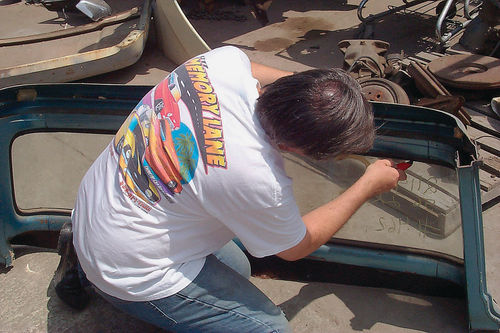 We cut the big back window sheet metal out of a damaged cab at Memory Lane, B pillars and all. Here we are carefully taking out the glass.