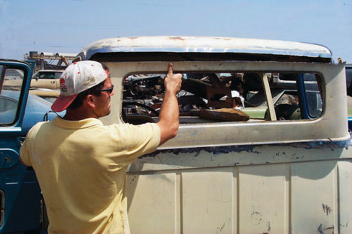 Carefully lift the small back window panel out and set it aside.