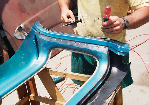 Carefully pop the outer sheet metal loose using a large screwdriver or stiff putty knife.