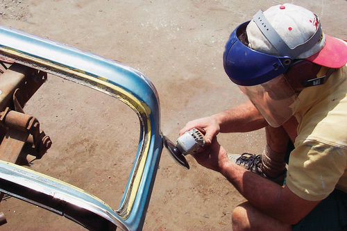 Use a grinder and 80-grit disc to clean away all paint and rust from the seam to be welded.