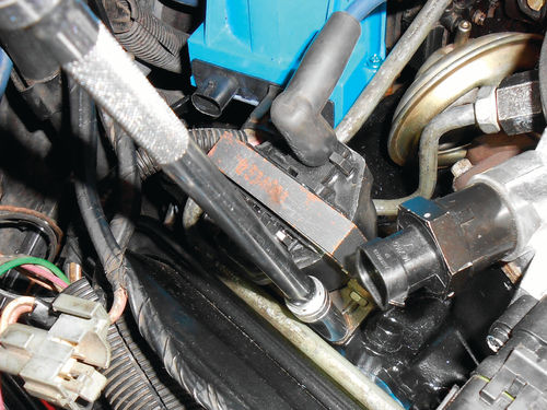 Two ¼” bolts with 3/8” heads secure the ignition coil to the intake manifold.